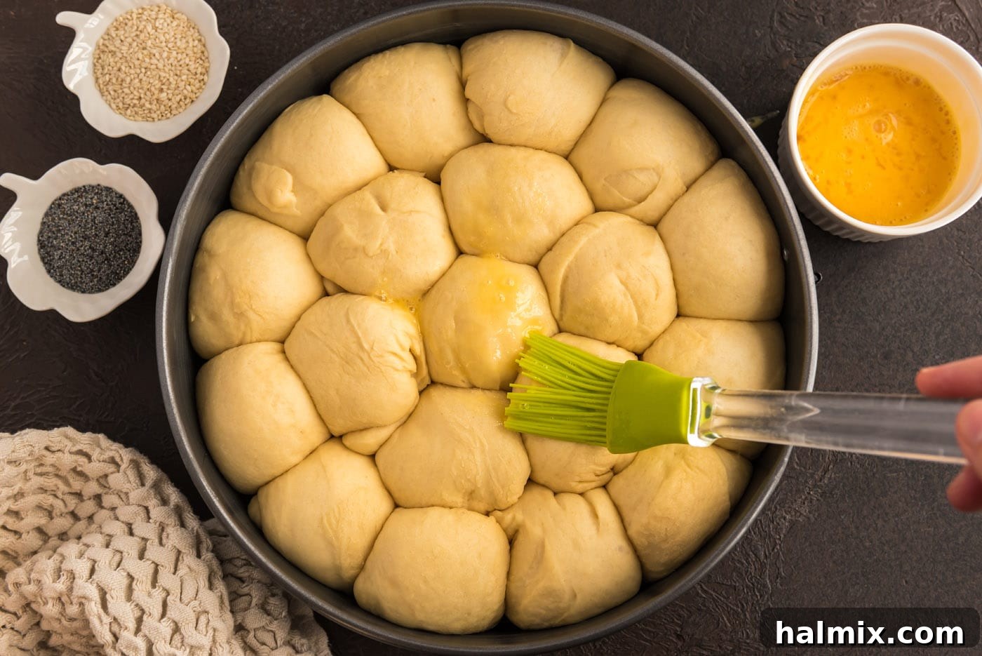 Festive German Bread 20 Brushing the tops of the risen dough balls with an egg wash before baking.