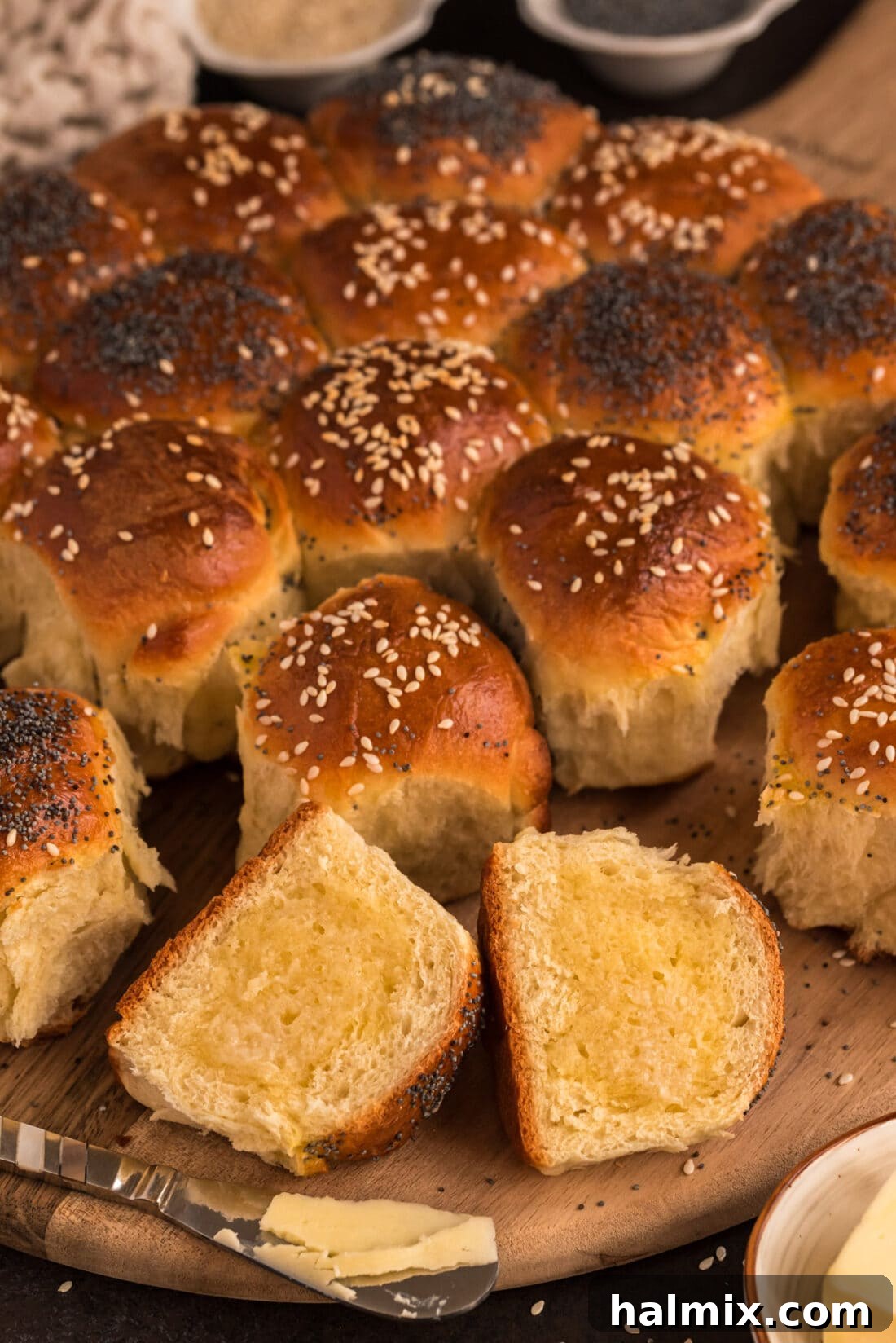 Festive German Bread 3 A Partybrot roll broken apart, showing its soft interior, with a pat of butter melting on top.