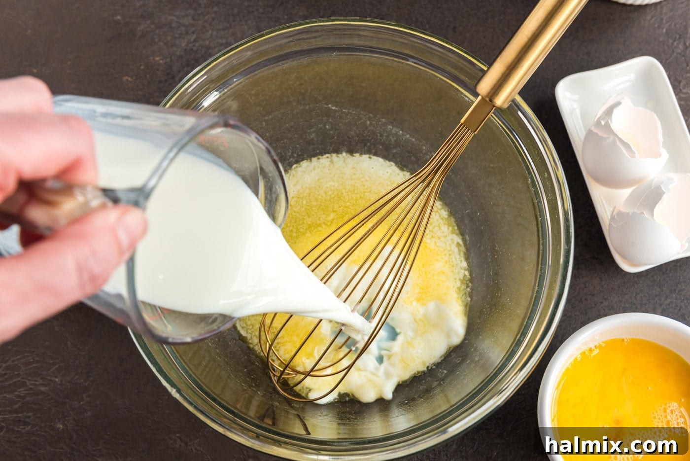 Festive German Bread 6 Pouring the remaining milk into a bowl containing melted butter and sugar.