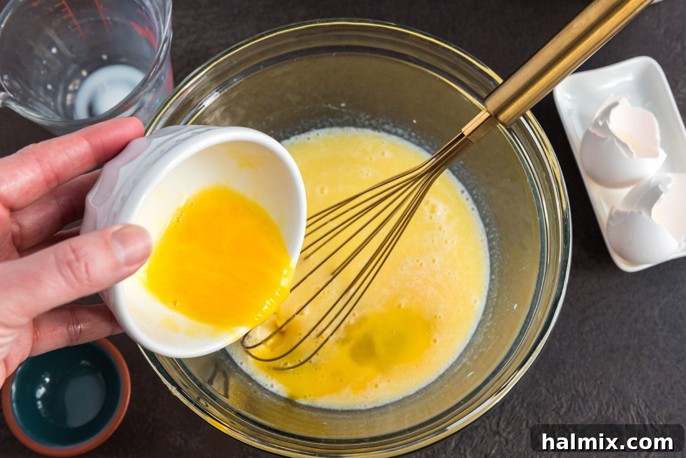 Festive German Bread 7 Adding beaten eggs to the butter, milk, and sugar mixture, ready for whisking.