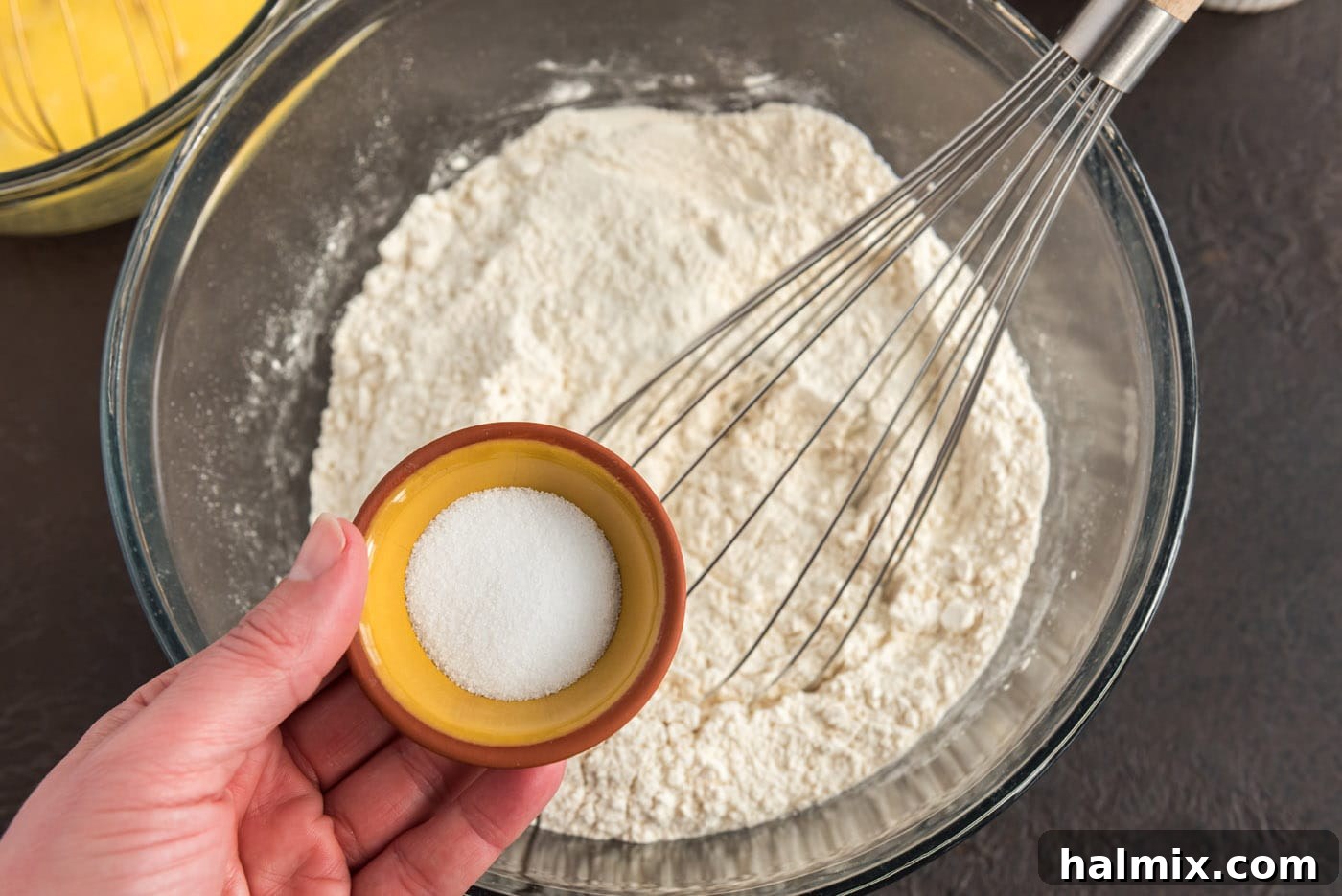 Festive German Bread 9 Adding salt to flour in a large bowl and whisking them together.