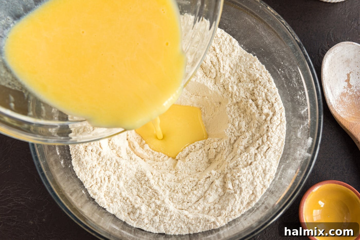 Festive German Bread 10 Pouring the melted butter and egg mixture into a well made in the center of the flour.