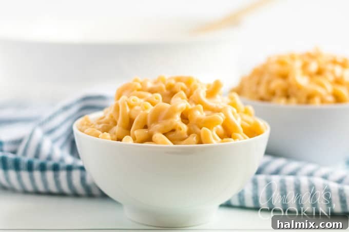 A large bowl of creamy stovetop macaroni and cheese, topped with fresh herbs, ready to be enjoyed.