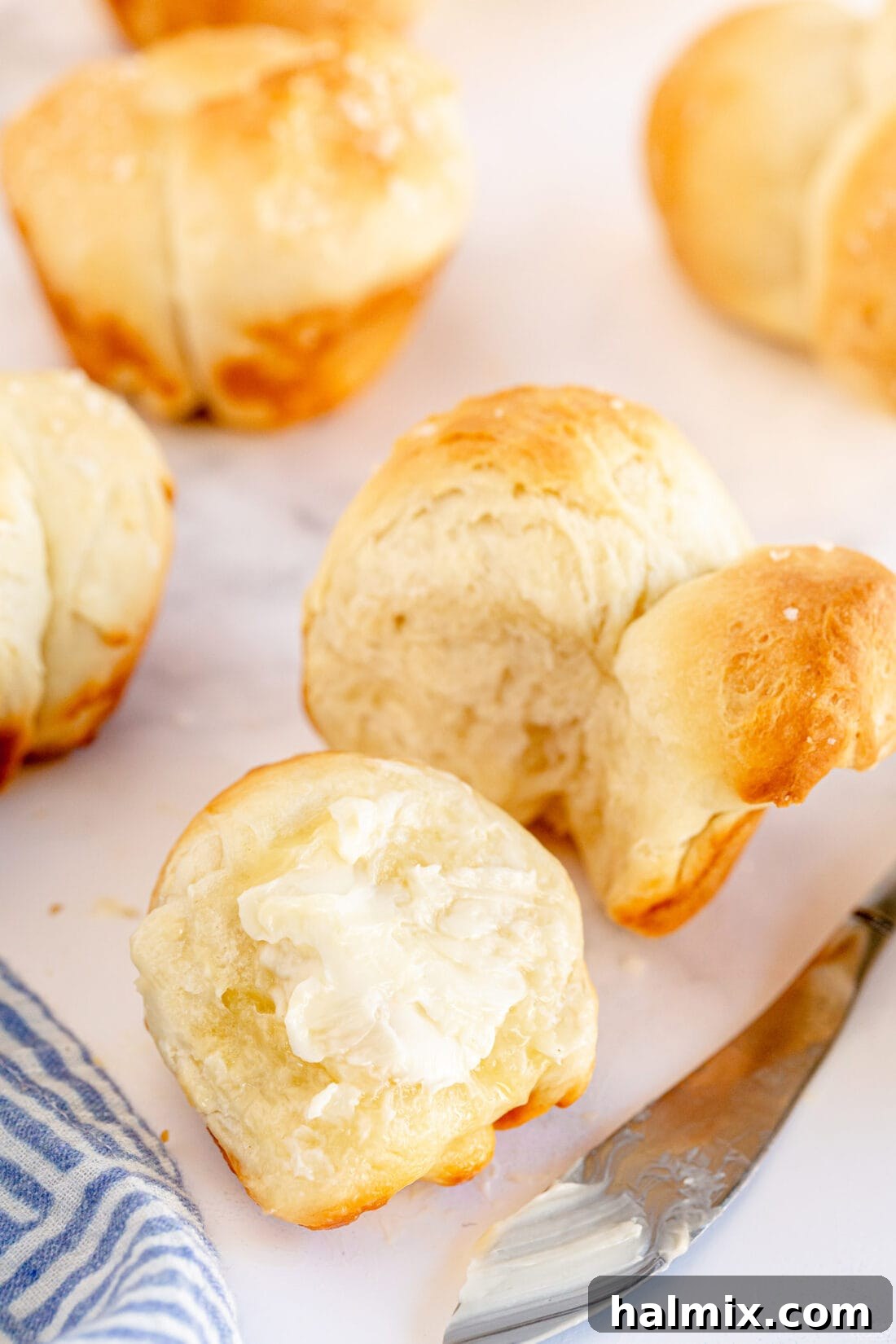 A warm, buttered Homemade Pull Apart Dinner Roll, ready to be enjoyed.