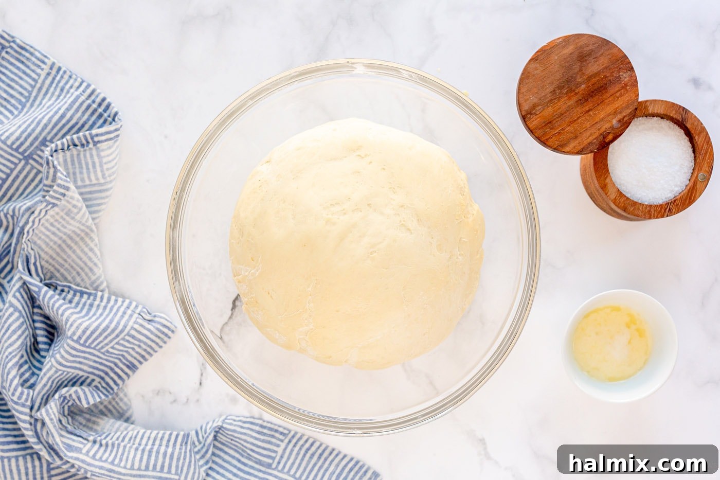 Risen dough in a bowl, visibly doubled in size and ready for shaping.