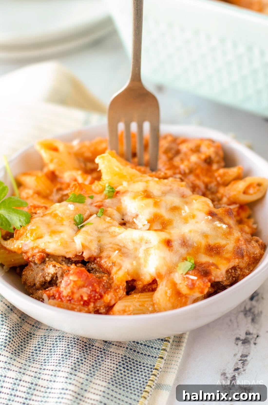 fork in a bowl of baked ziti