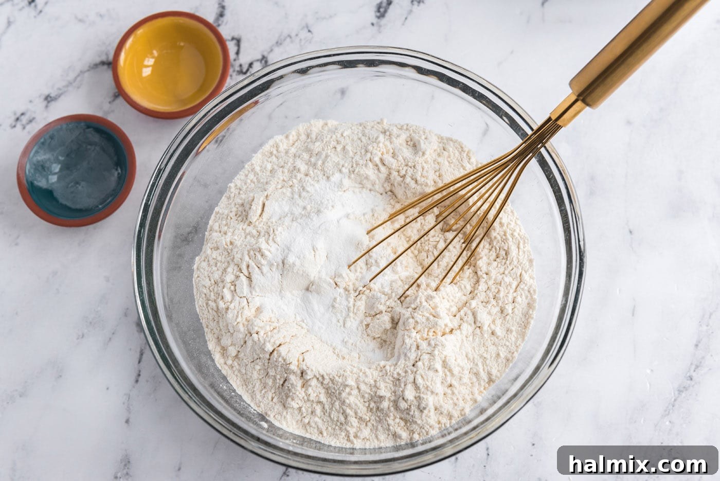whisking flour, baking powder, and salt in a bowl