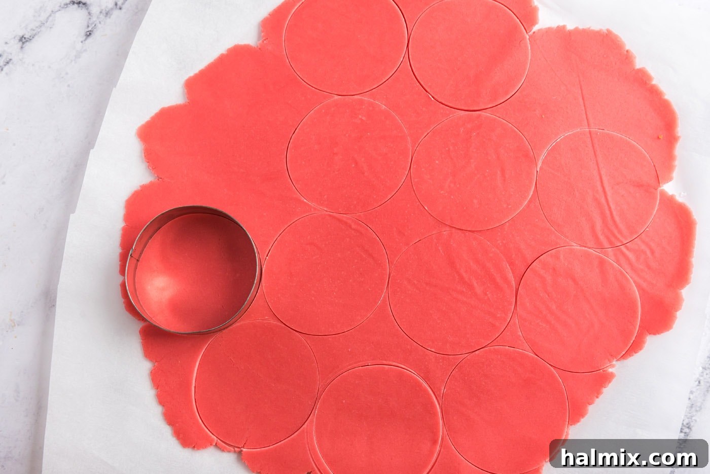 cutting circles out of sugar cookie dough