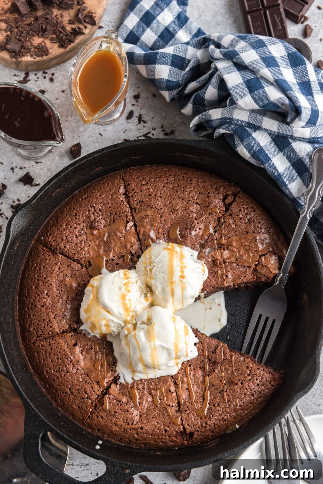 Brownies in a Cast Iron Skillet with a slice removed and a fork resting in the pan