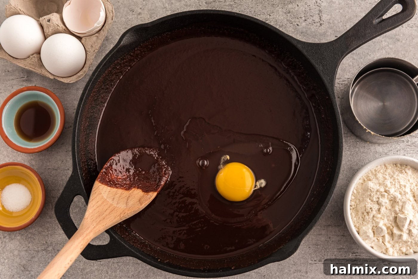 mixing egg into chocolate mixture in a skillet