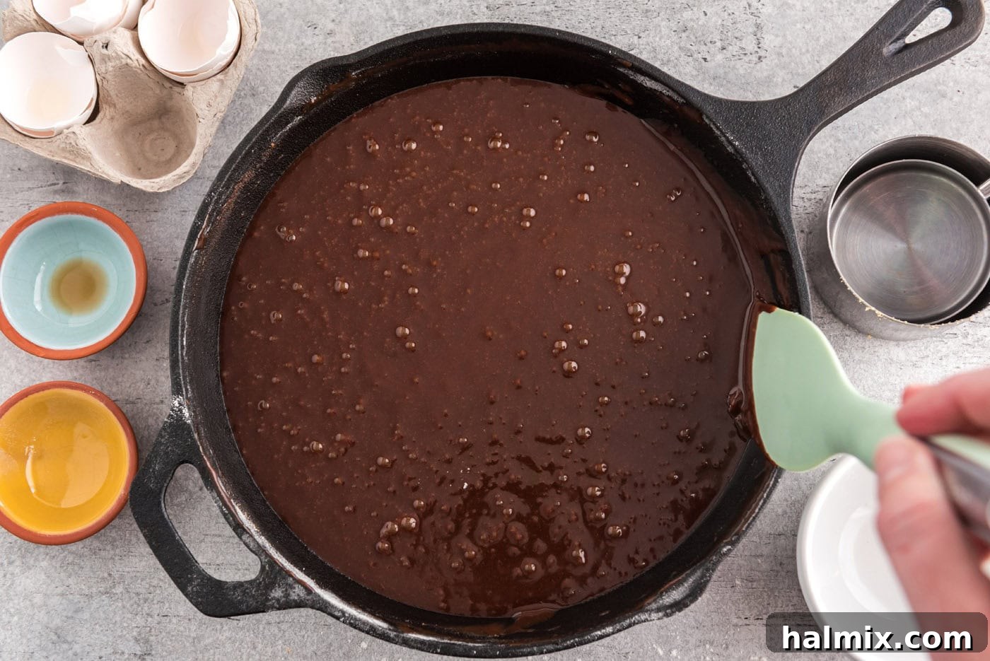 cleaning edges of brownie skillet with a rubber spatula