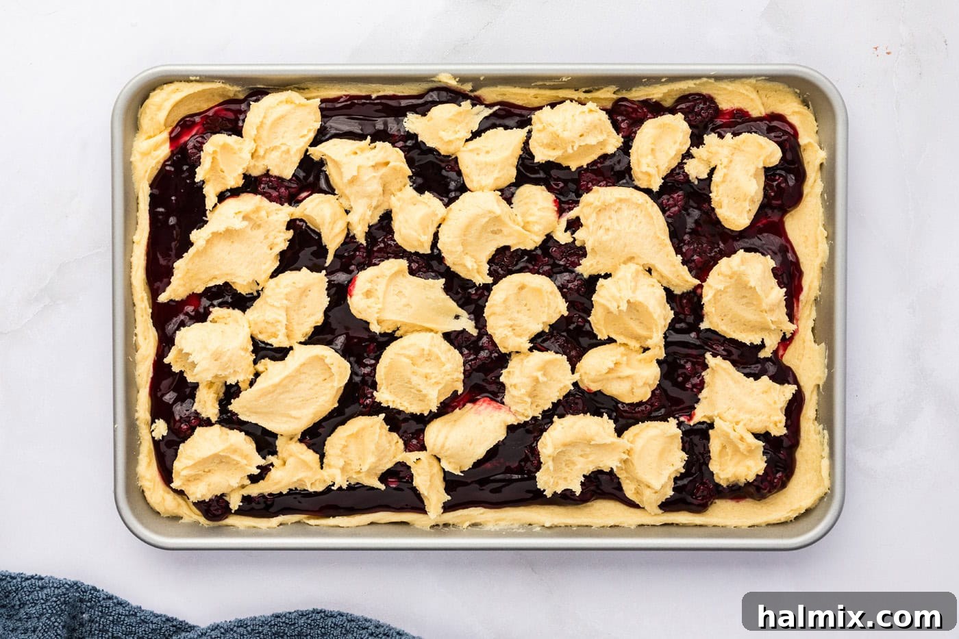 dollops of cookie dough batter on top of blackberry pie filling