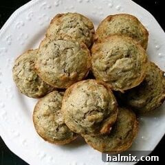 An overhead photo of vanilla zucchini muffins on a white plate, ready to be served.