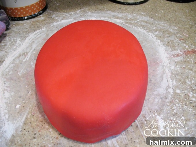 Spiderman Cake Power-Up: Homemade Marshmallow Fondant 6 A photo of a a cake covered in red fondant.