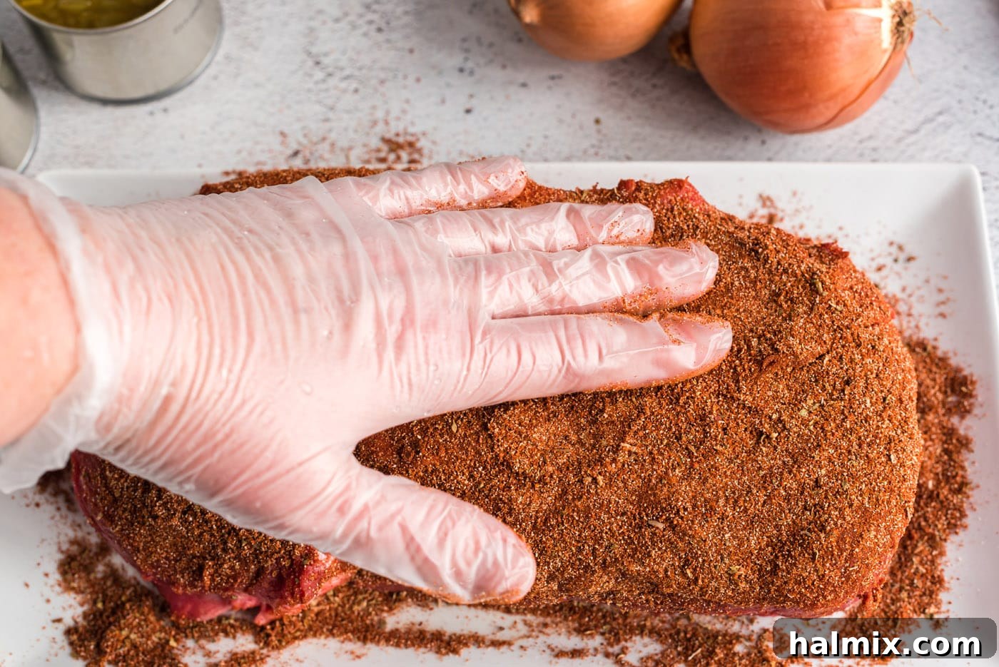 rubbing seasoning into chuck roast