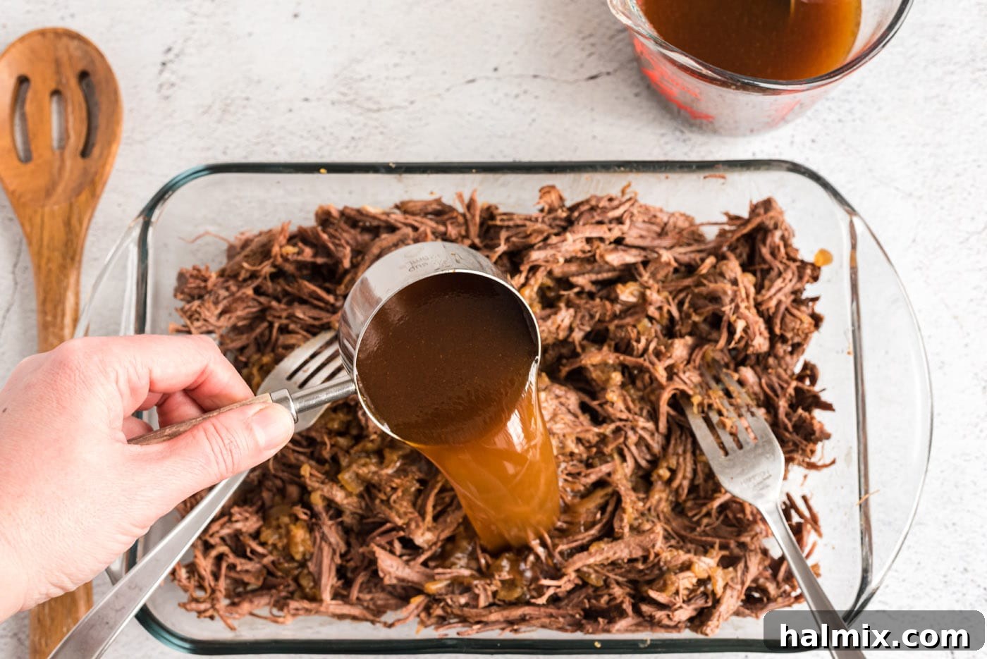 pouring beef juice into chuck roast