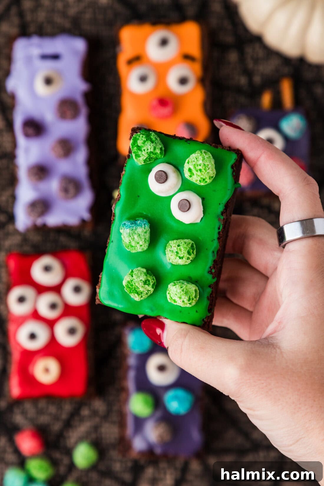 Hand holding up a Monster Brownie, showcasing its fun decorations