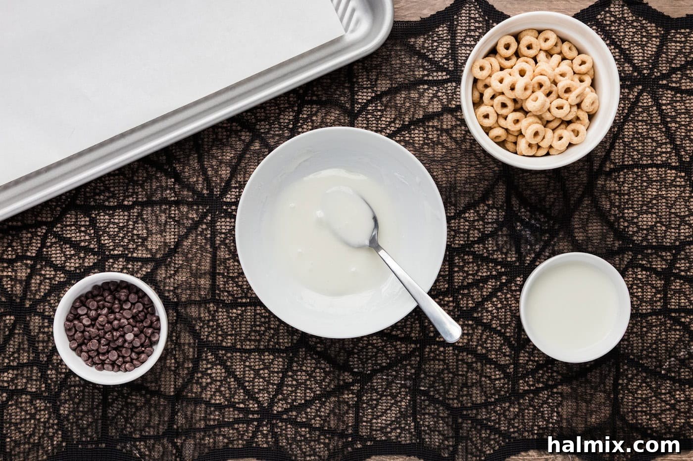 Powdered sugar and milk glaze in a bowl with a spoon, showing proper consistency