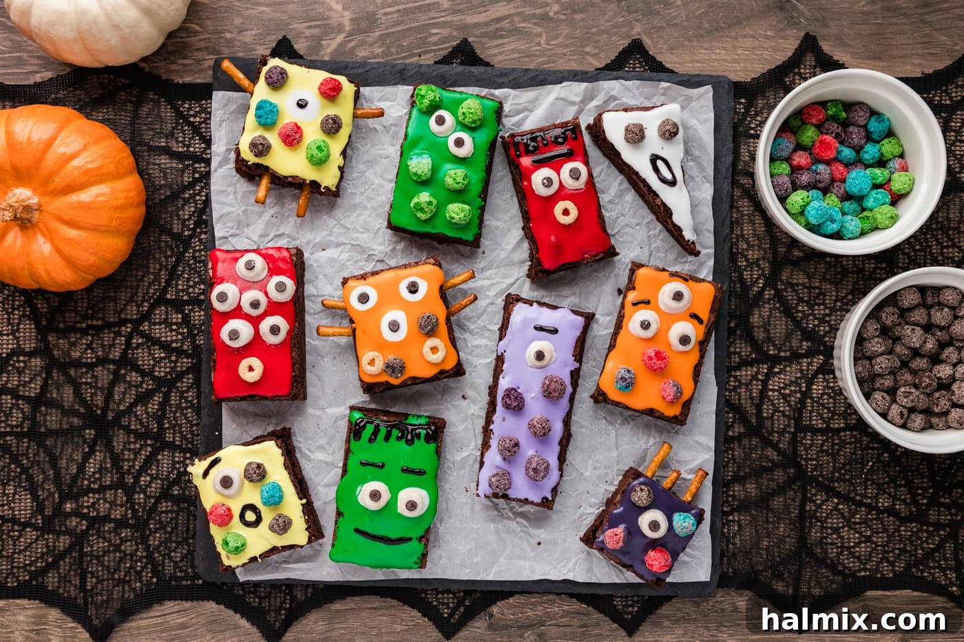Decorated monster brownies on a parchment paper sheet, showing various designs