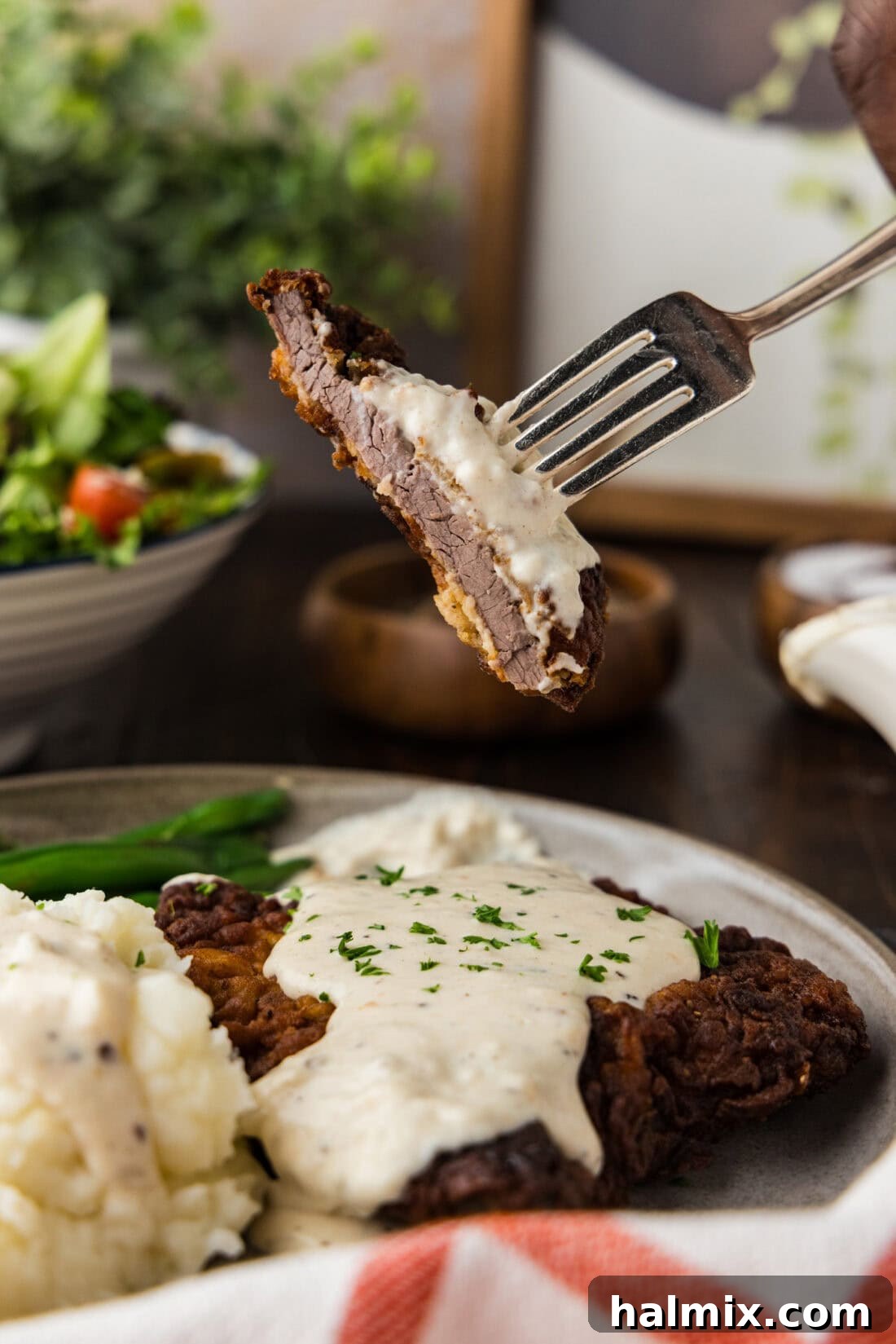 Piece of Chicken Fried Steak on a fork