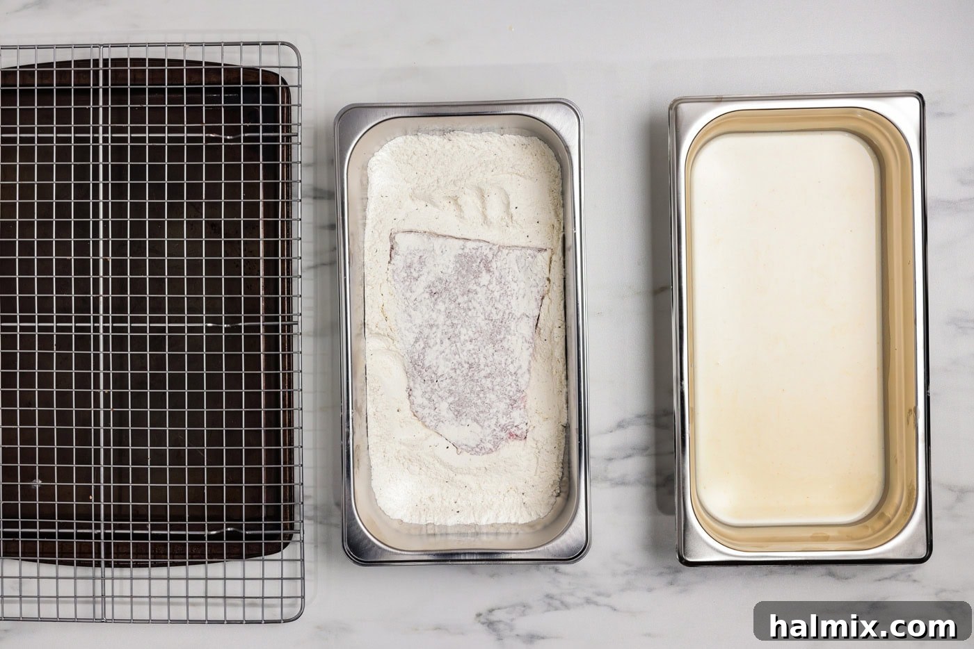 cube steak in a breading tray with flour mixture