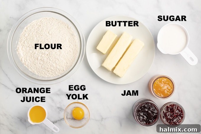 A collection of ingredients for thumbprint cookies, including butter, sugar, egg yolk, orange juice, flour, and a variety of colorful jams, laid out on a wooden surface.