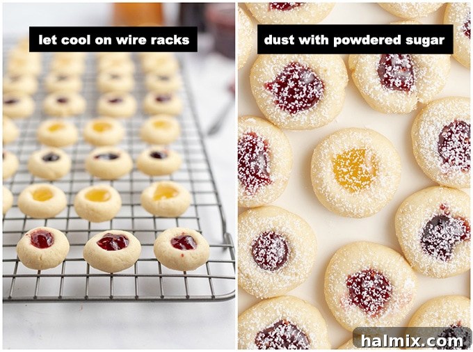 A baking sheet with thumbprint cookies, where one cookie is being dusted with powdered sugar, adding a finishing touch to the warm, jam-filled treats.