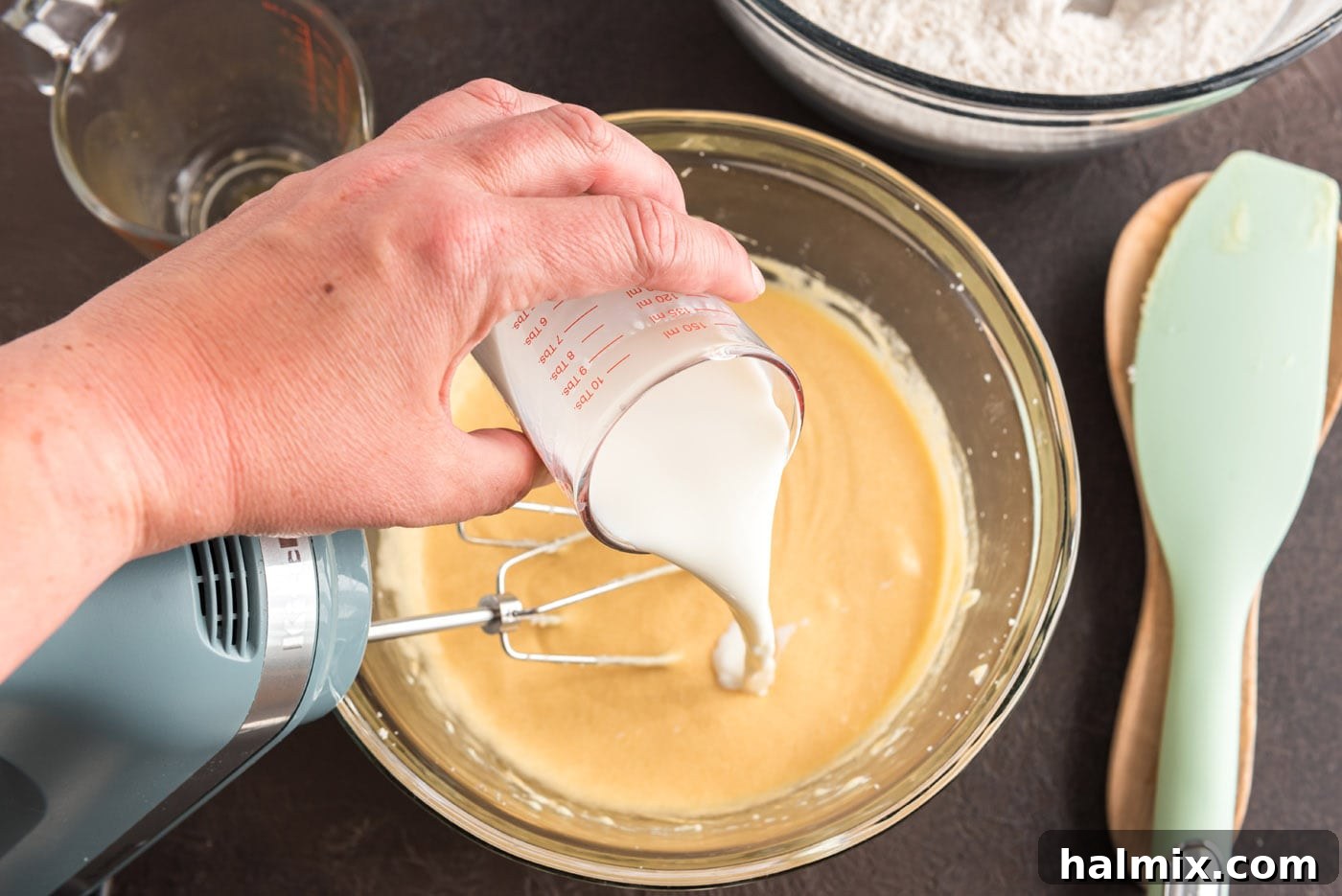 Pouring buttermilk into the apple cider donut batter