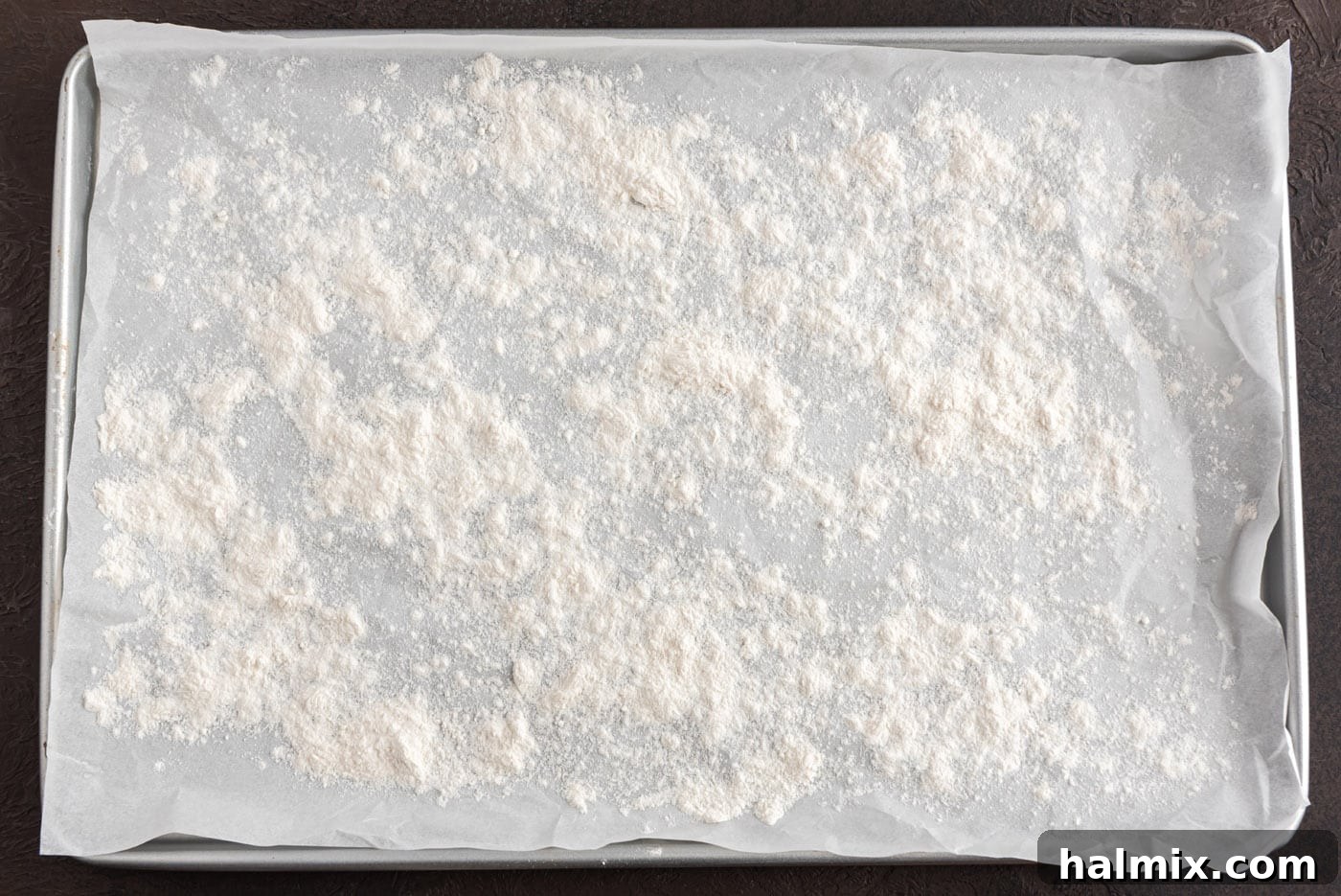 Flour generously sprinkled on a work surface, ready for the dough