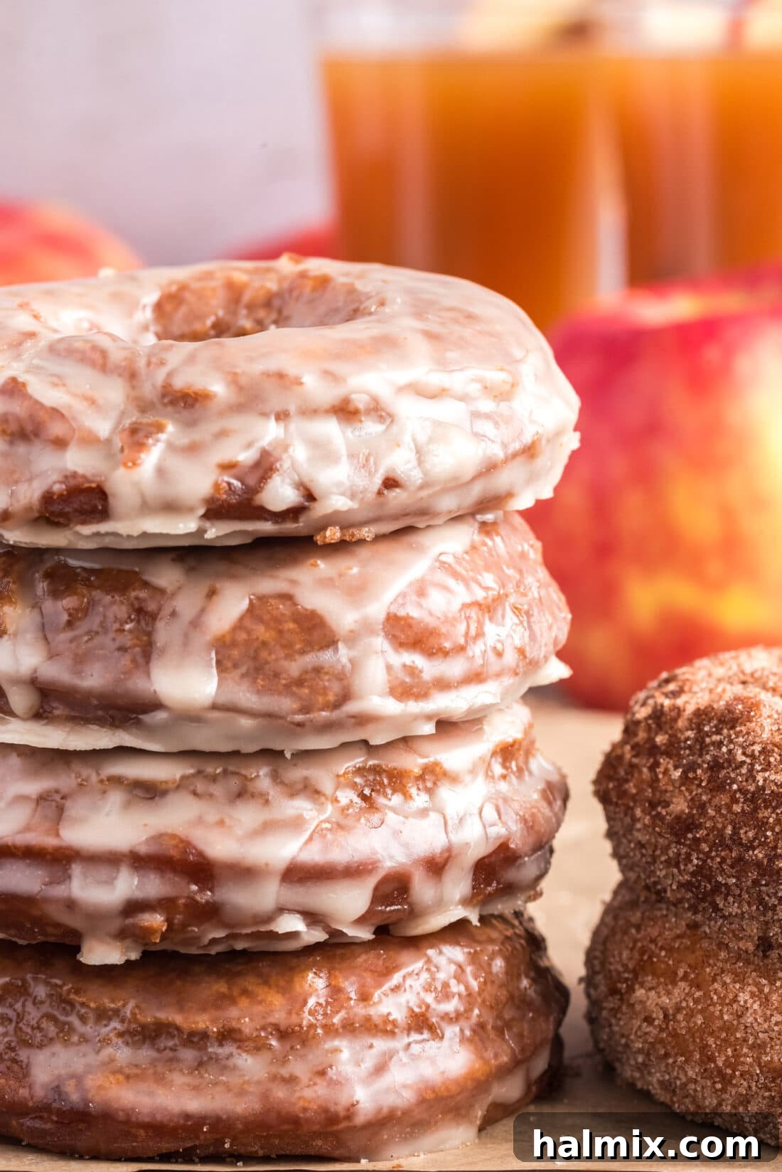 Stack of glazed Apple Cider Doughnuts, showcasing their beautiful shiny topping