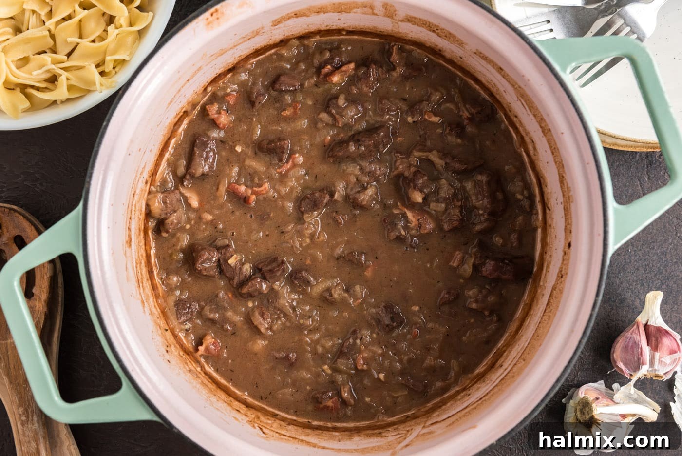 The Beef Carbonnade simmering beautifully in a Dutch oven, its rich gravy and tender beef promises a delicious meal.