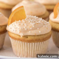 Close up photo of a perfectly frosted Orange Creamsicle Cupcake.