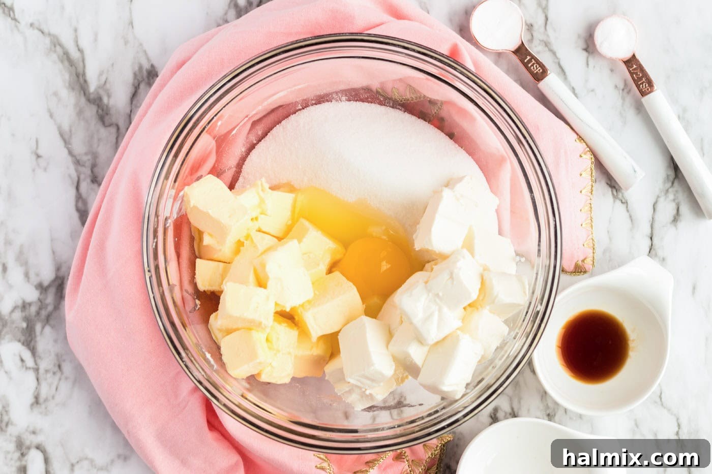 Frosted Sugar Cookie Bars: The Easiest Way to Indulge 5 Vanilla and almond extract added to a bowl of butter, cream cheese, sugar, and egg batter