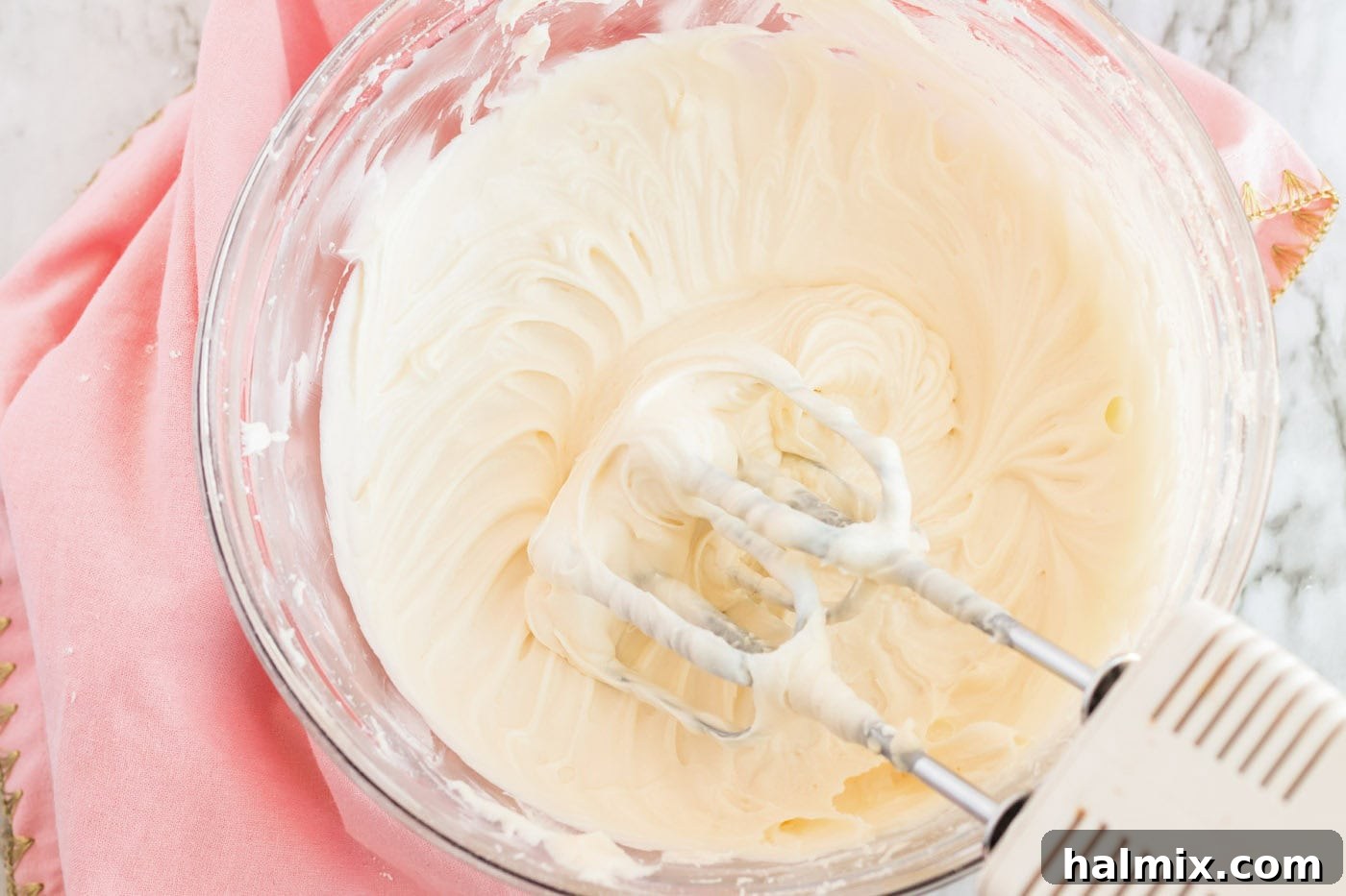 Frosted Sugar Cookie Bars: The Easiest Way to Indulge 9 Frosting in a bowl with a hand mixer resting on the side