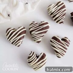 Heart shaped chocolates with white drizzles, a festive Valentine's Day treat.