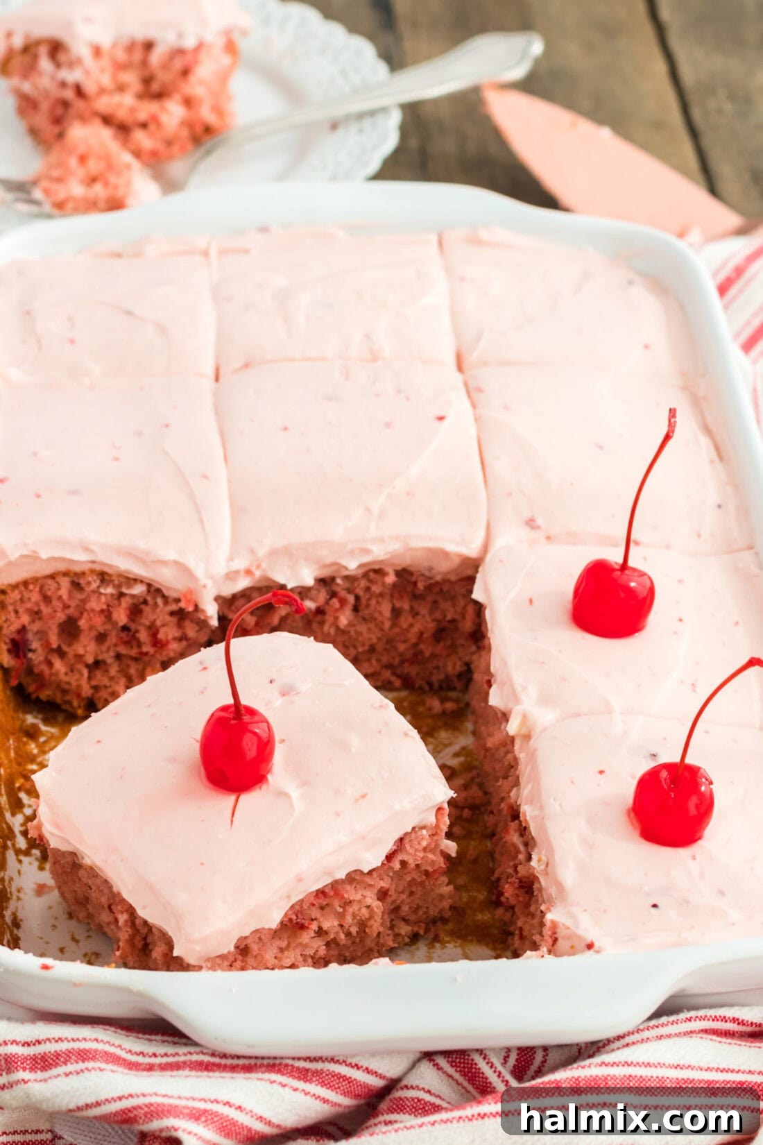 pan of cherry cake topped with maraschino cherries