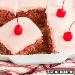 Slice of Cherry Cake with Cherry Frosting in a 13x9 pan