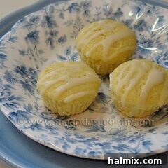 A close up photo of three German mini lemon cakes in a blue and white dish.