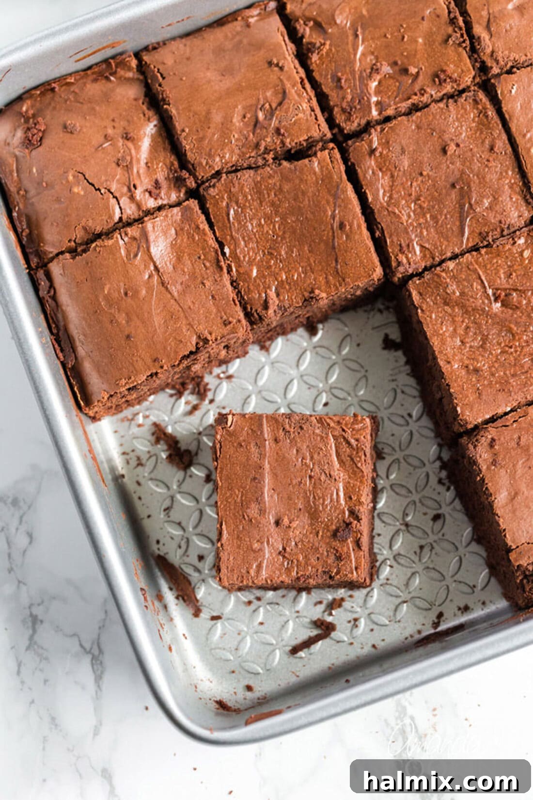 Freshly Baked Chocolate Cheesecake Brownies Ready to Be Enjoyed A baking pan filled with freshly baked Chocolate Cheesecake Brownies, with a few squares already removed