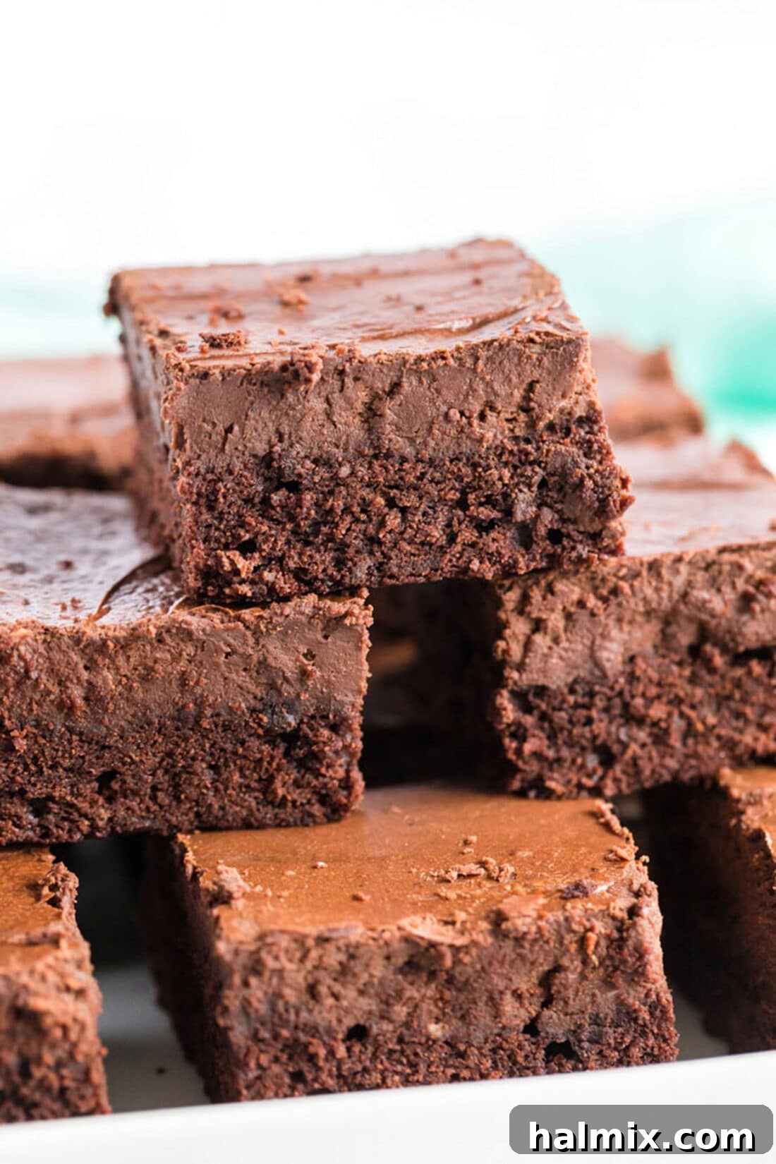 Perfectly Layered Chocolate Cheesecake Brownies A delightful stack of three Chocolate Cheesecake Brownies, showcasing their beautiful layers