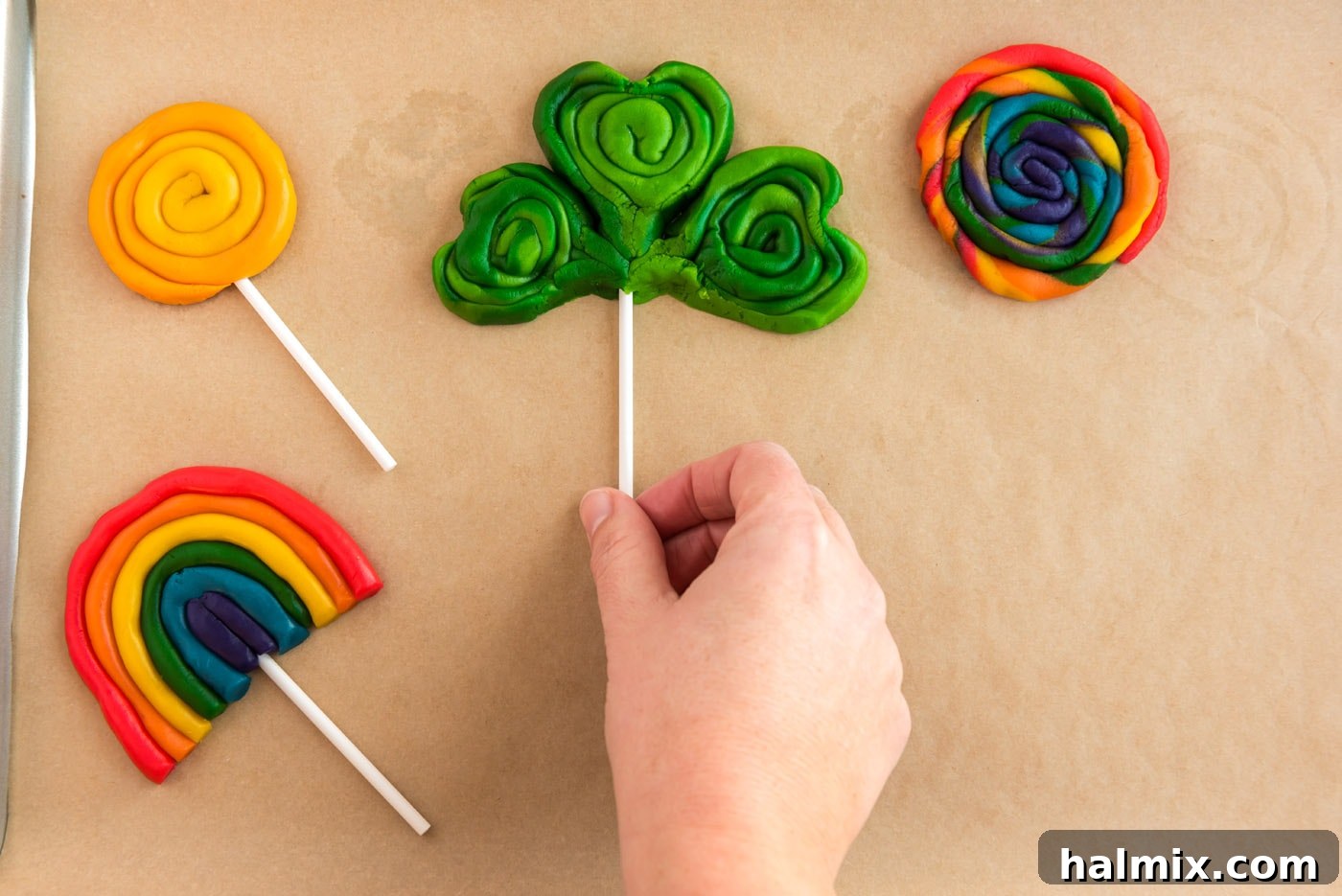 adding lollipop sticks to shamrock cookies