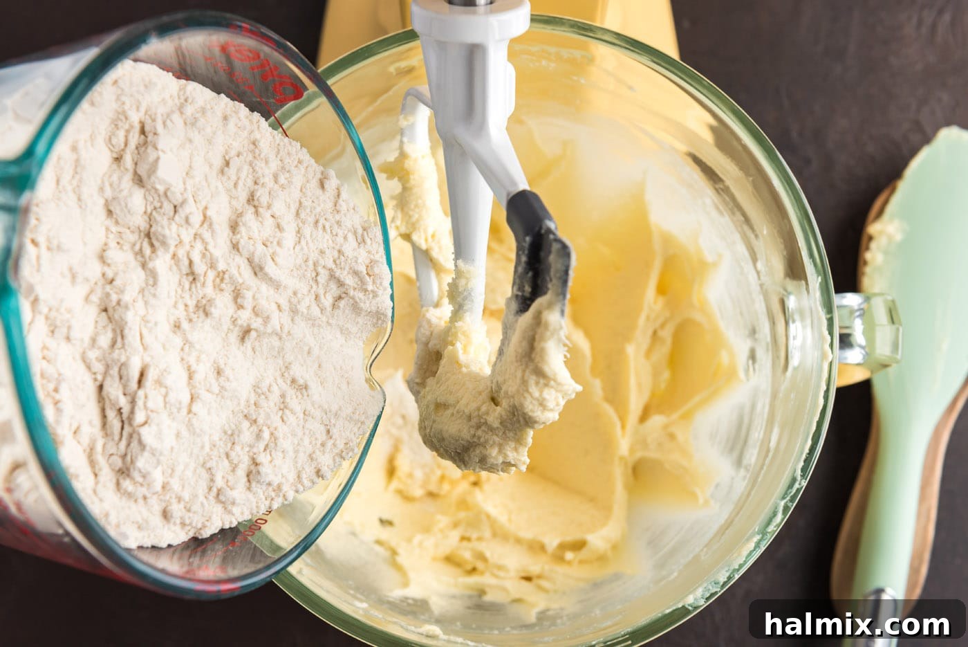 adding dry ingredients to wet ingredients in a stand mixer