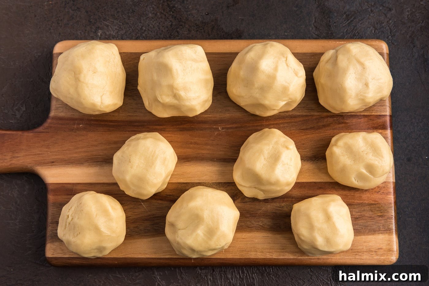 sugar cookie dough balls on a cutting board