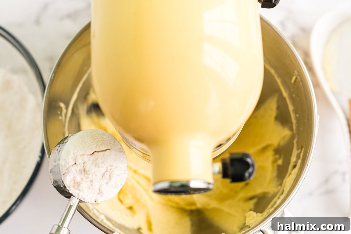 adding flour to mixer