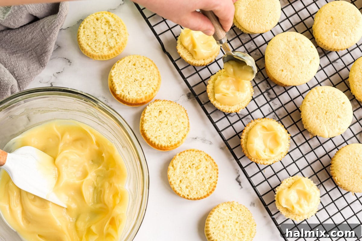 spooning pudding onto a sliced cupcake