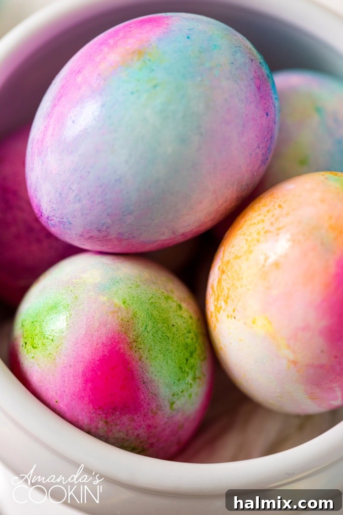 Tie Dye Easter Eggs: A creative and fun way to decorate for Easter, perfect for kids to make unique, beautifully colored eggs! Beautifully tie-dyed Easter eggs with vibrant colors