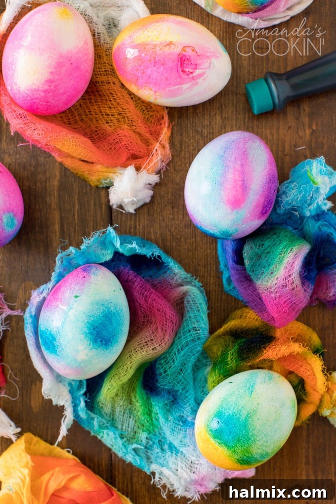 Tie Dye Easter Eggs are super fun for kids to get creative and create tons of different beautifully colored Easter eggs! Try these tie dye method this year! Easter eggs being dyed using the cheesecloth method