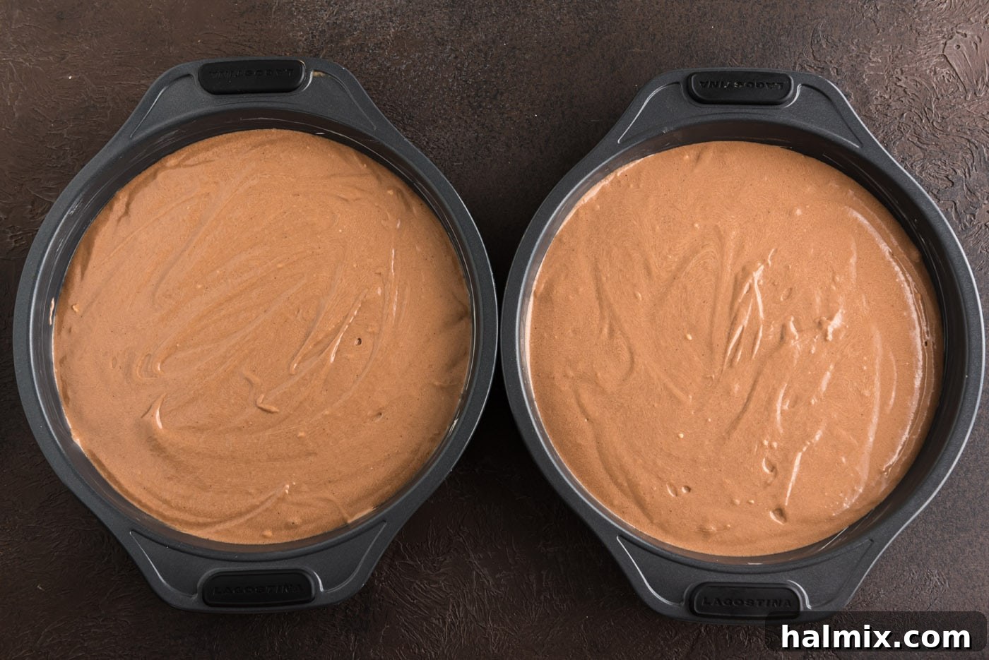 chocolate fudge cake batter in cake pans