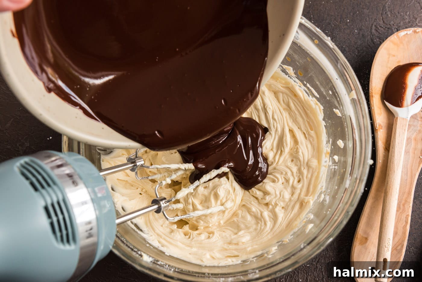 adding melted chocolate to frosting