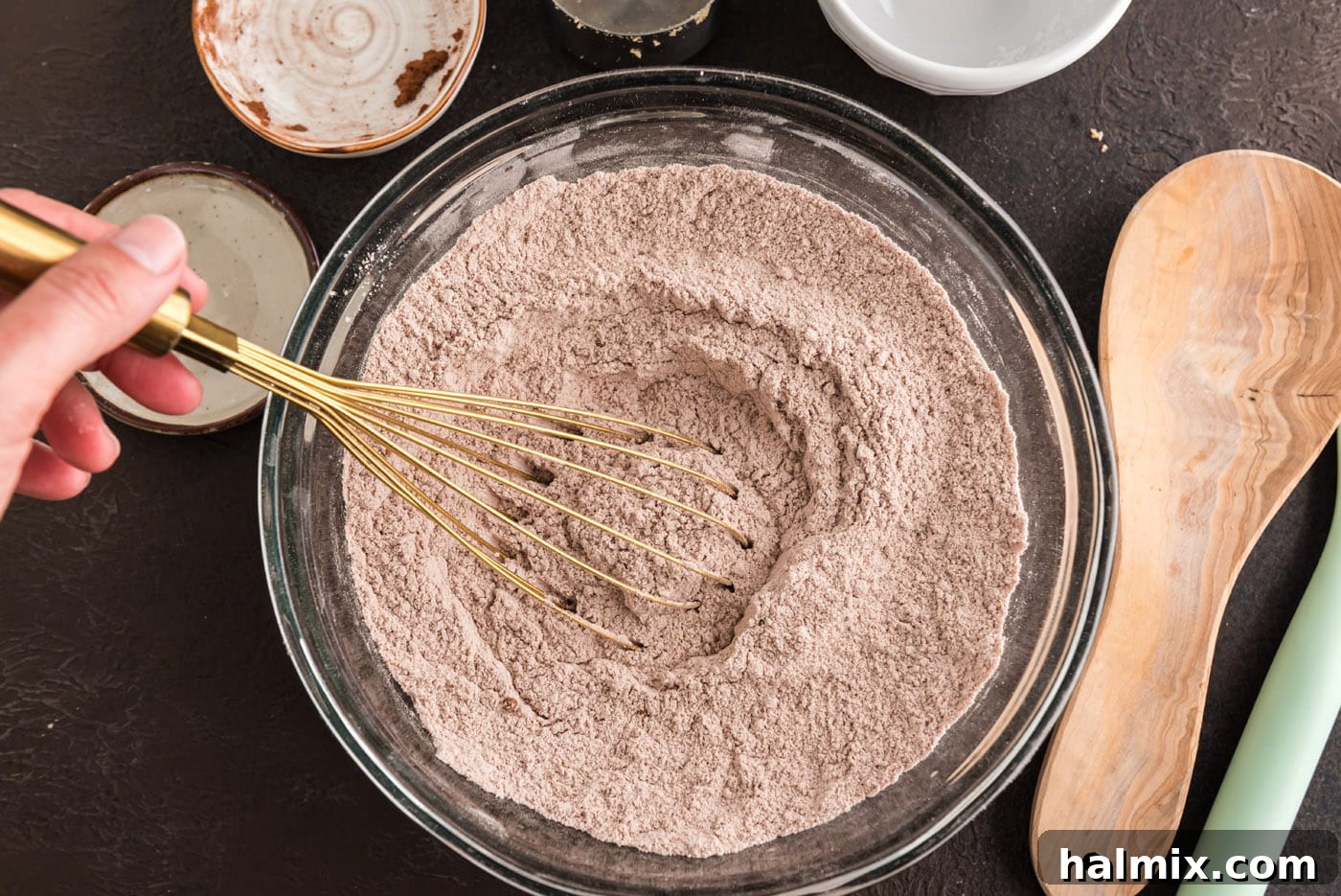 whisking together dry ingredients for chocolate cake